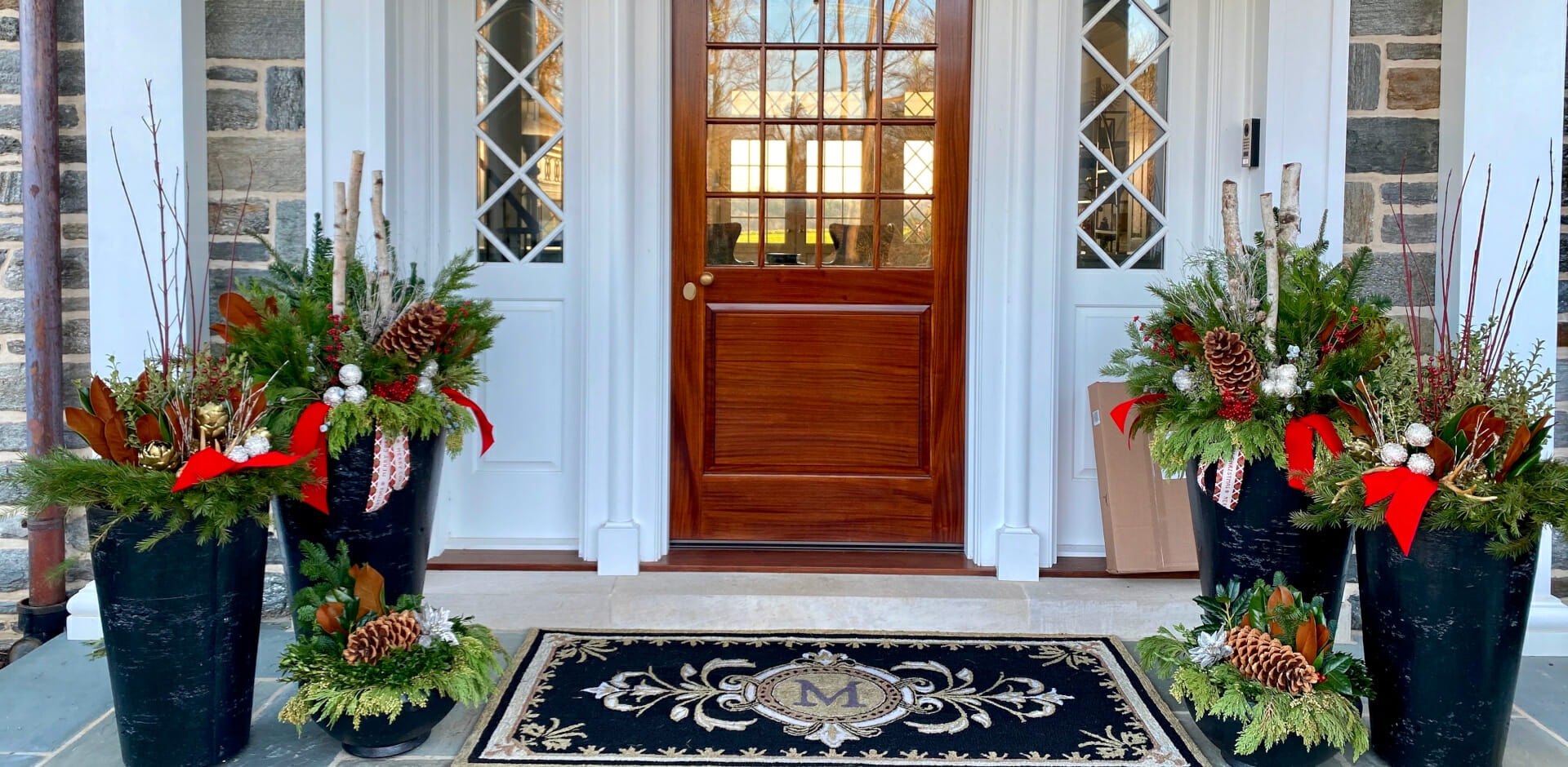 winter and holiday urns with seasonal plants, evergreens and blooms